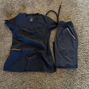 Large lot of scrubs.  Sizes XXS & XS